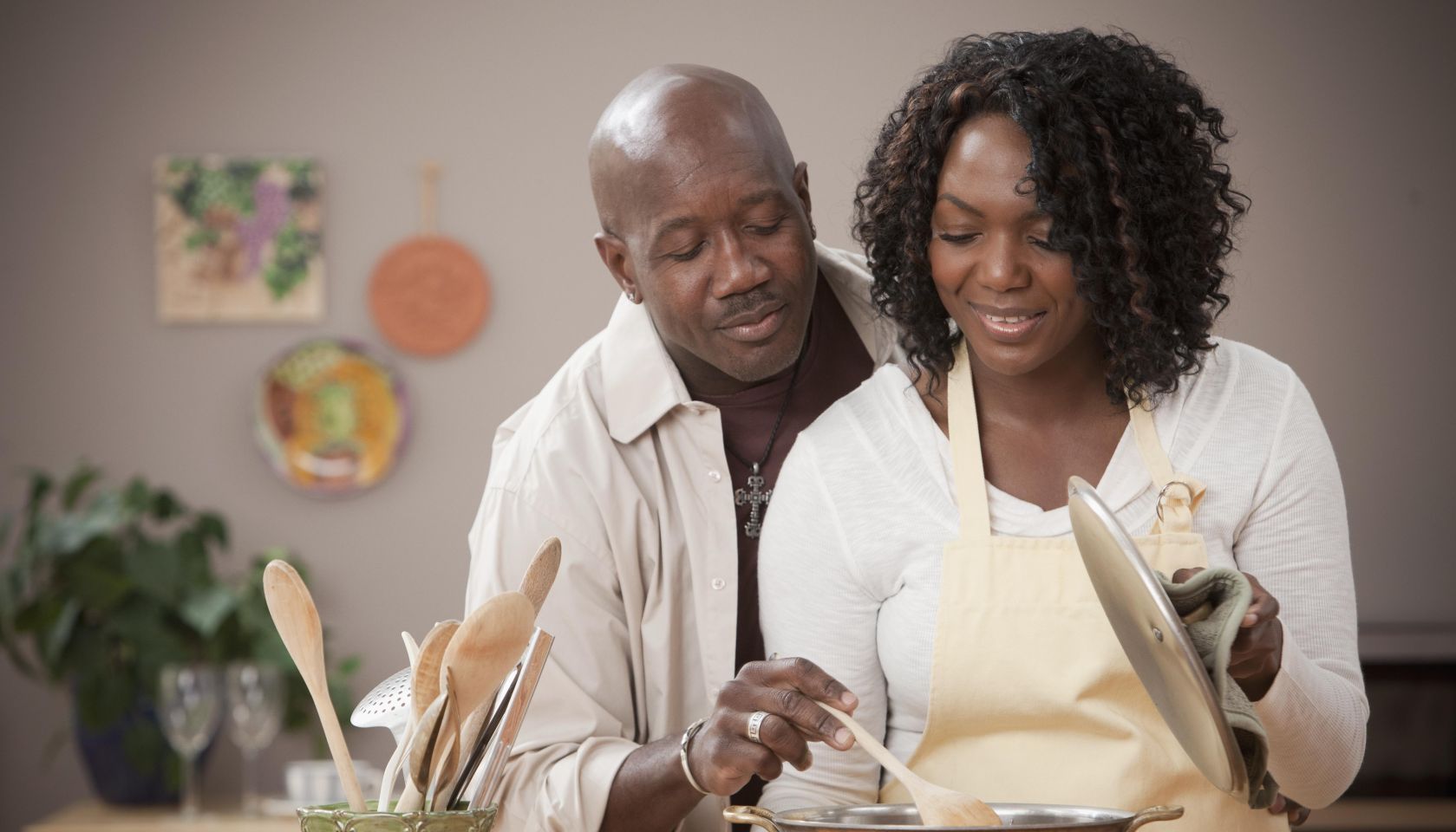 African American couple cooking together