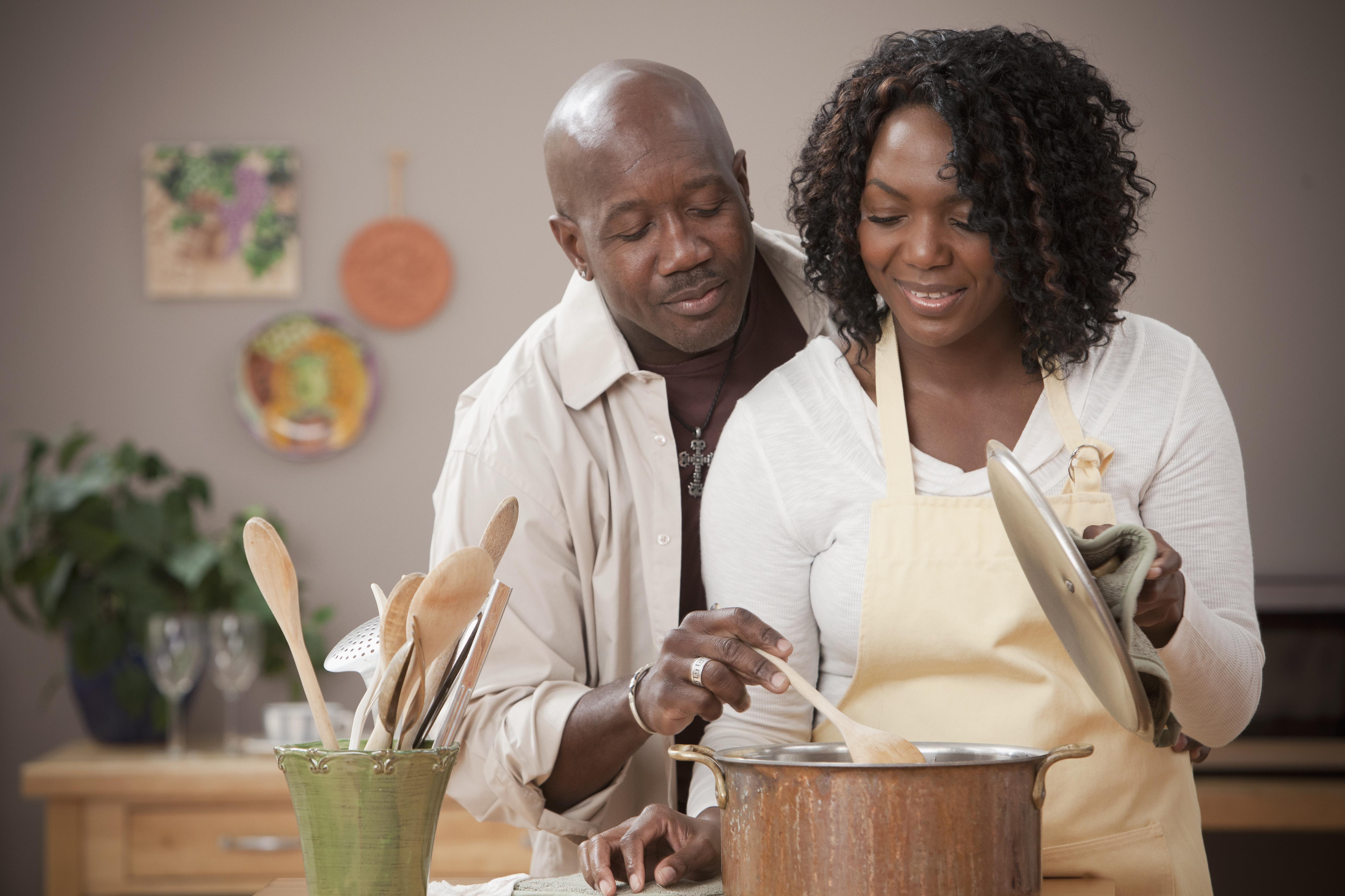 African American couple cooking together