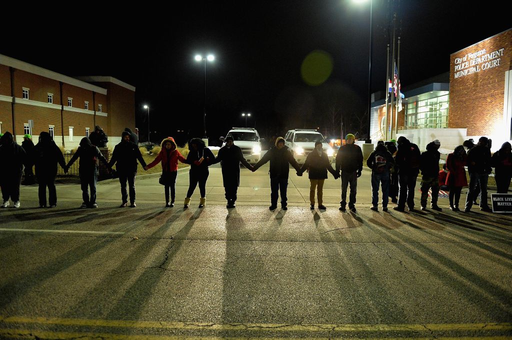 Protestors demonstrate in front of Ferguson Police Station