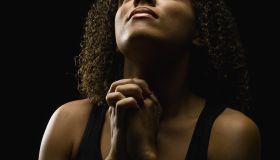 Beautiful young woman praying
