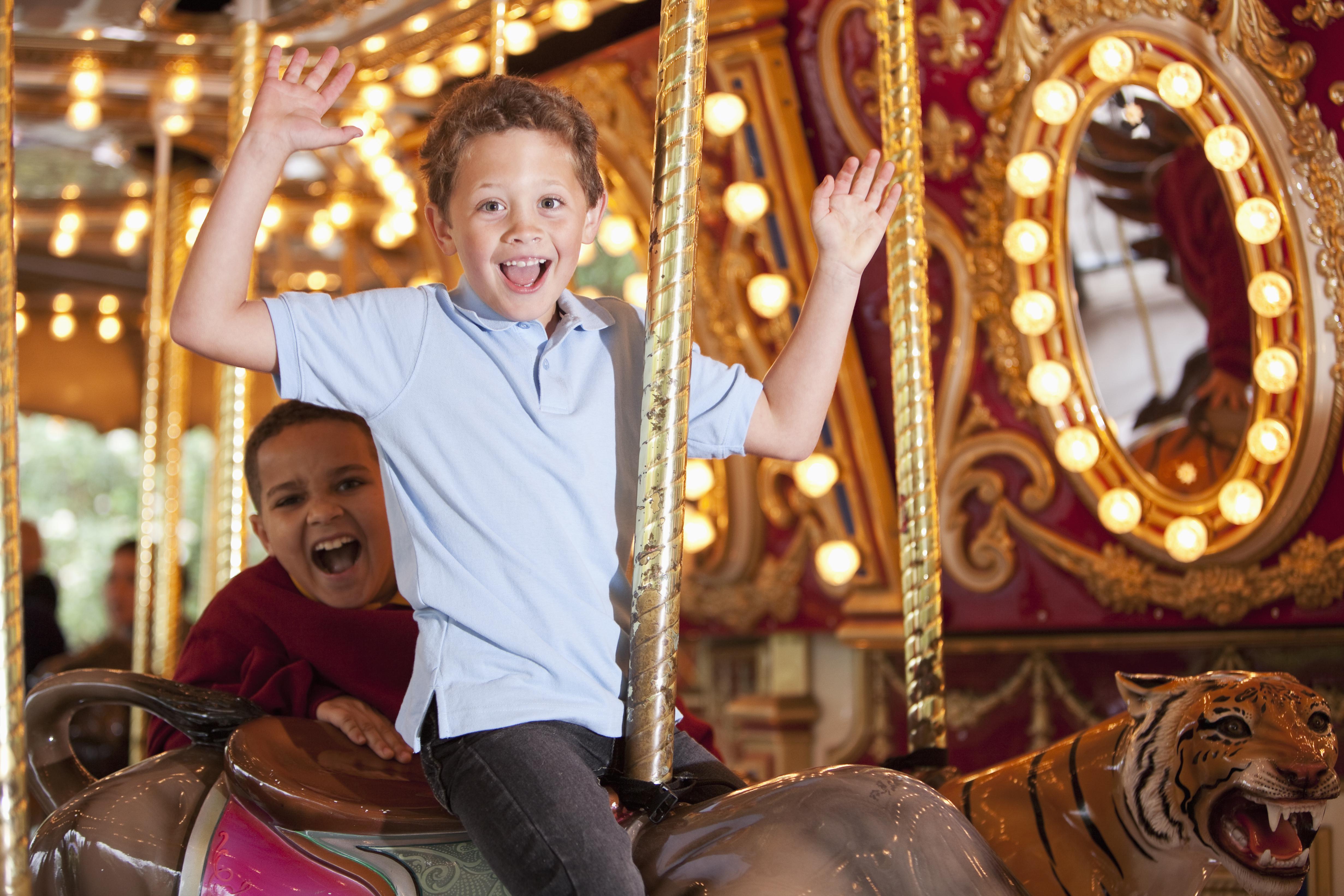 Boys riding carousel