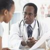 African male doctor talking to patient