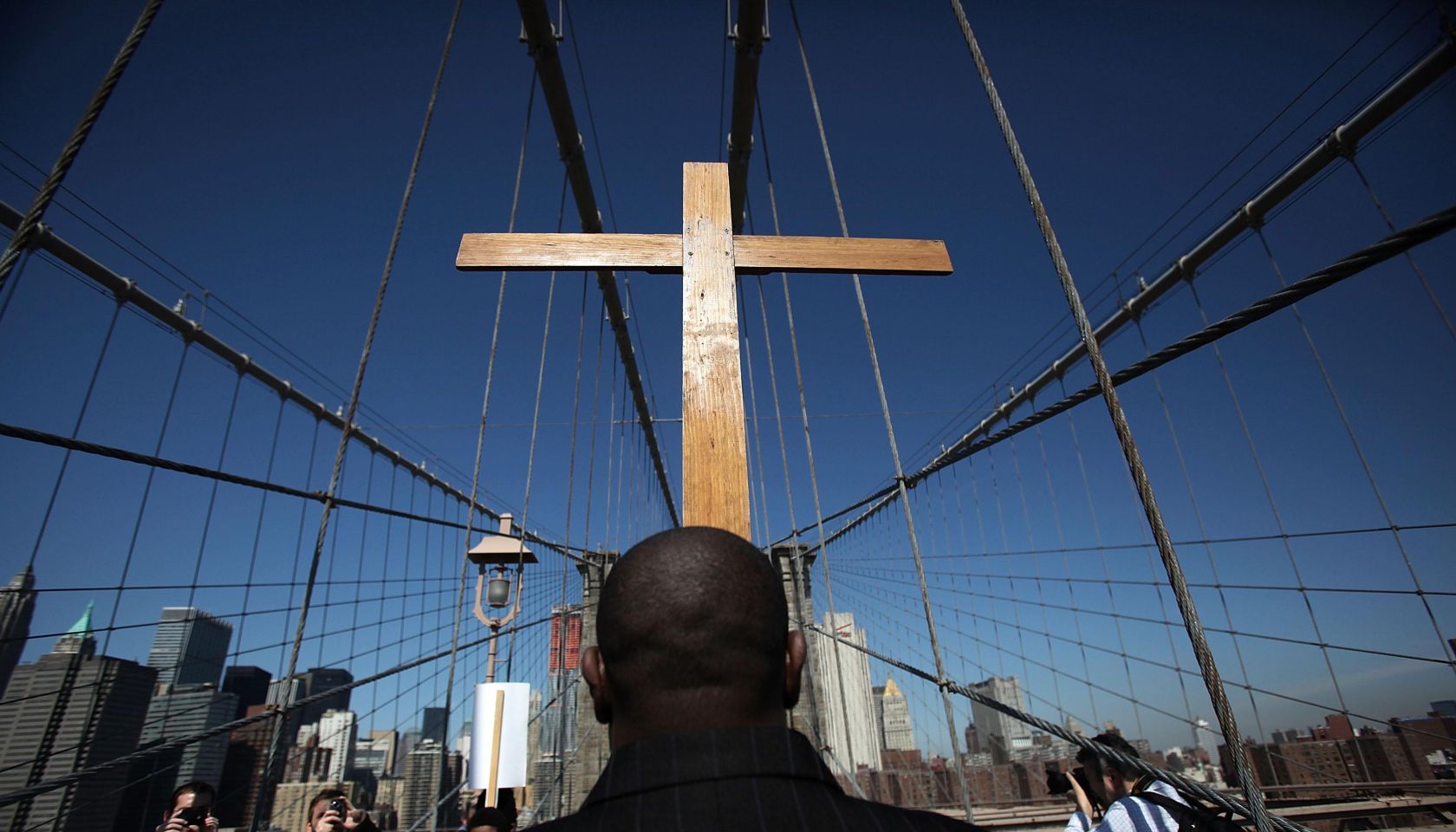 Way Of The Cross Procession Crosses Over New York's Brooklyn Bridge