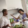 Couple in the kitchen together, busy mom on telephone