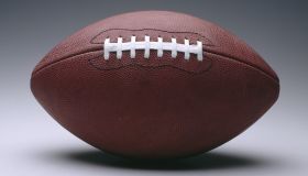 American football with white seam, plain background