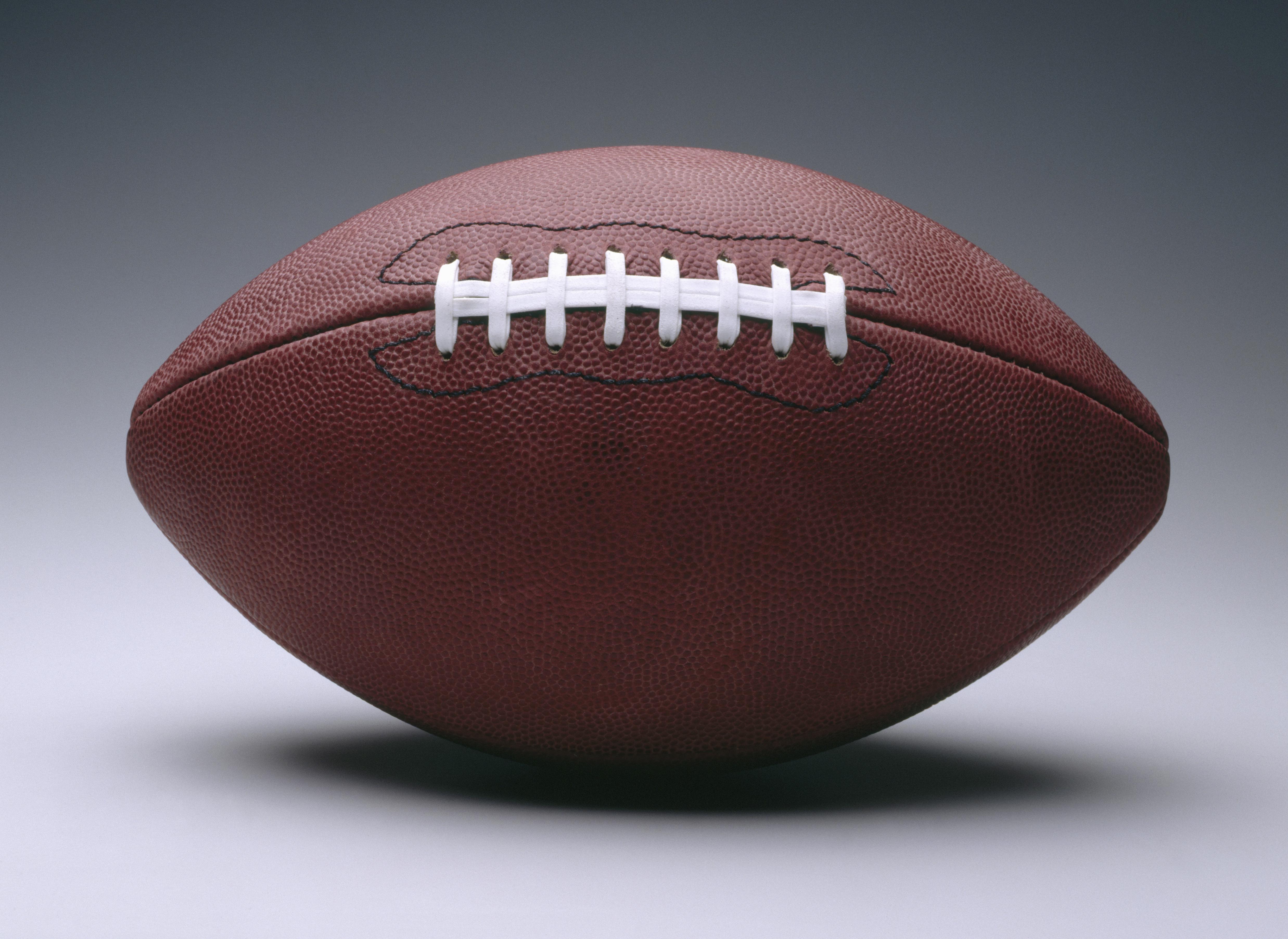 American football with white seam, plain background
