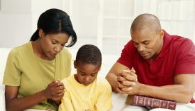 Parents with son (6-9) praying