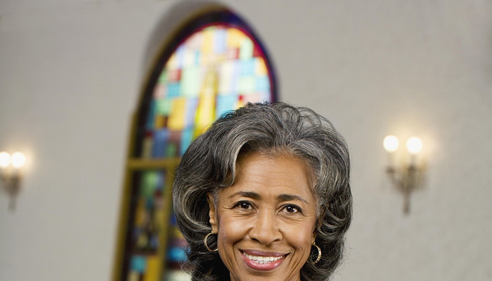 African American female Reverend holding Bible