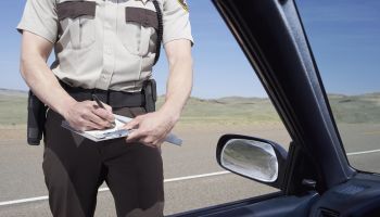 highway patrolman writing ticket