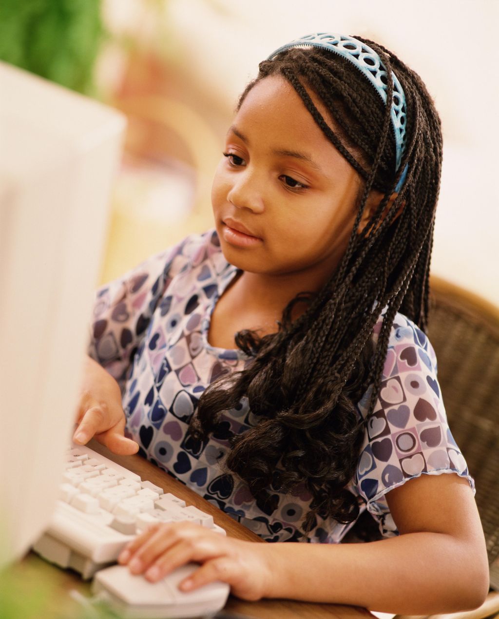 Girl (7-9) using computer, close-up