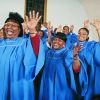 Twelve Gospel Singers With Raised Hands Singing in a Church Service