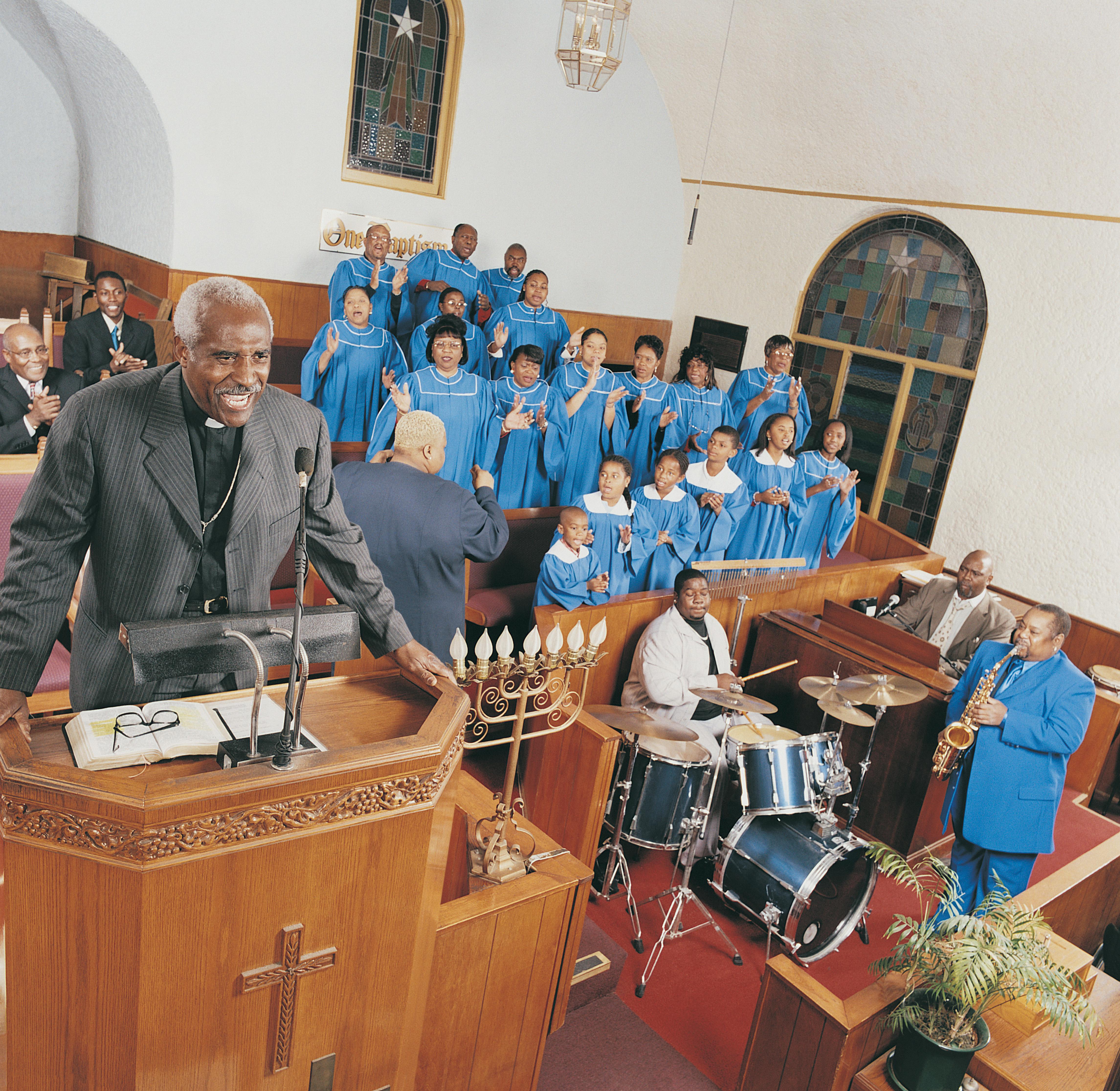 Gospel Choir and Band Playing at a Church Service With a Priest Standing on a Pulpit