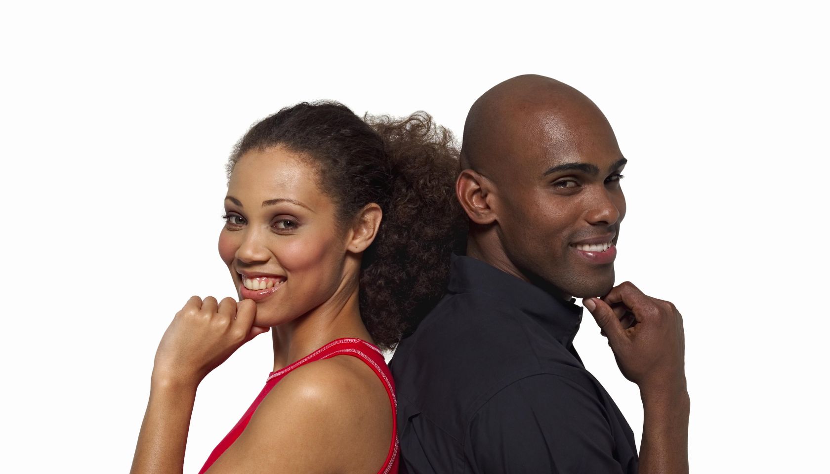 Close-up of young couple standing back to back