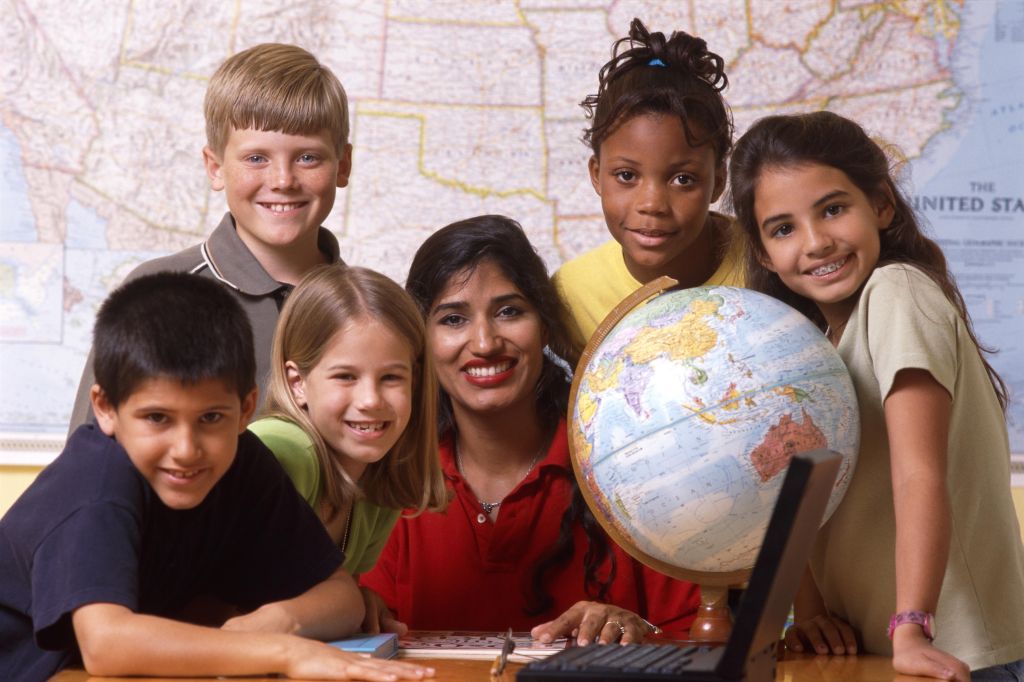 Teacher and students with world globe and laptop