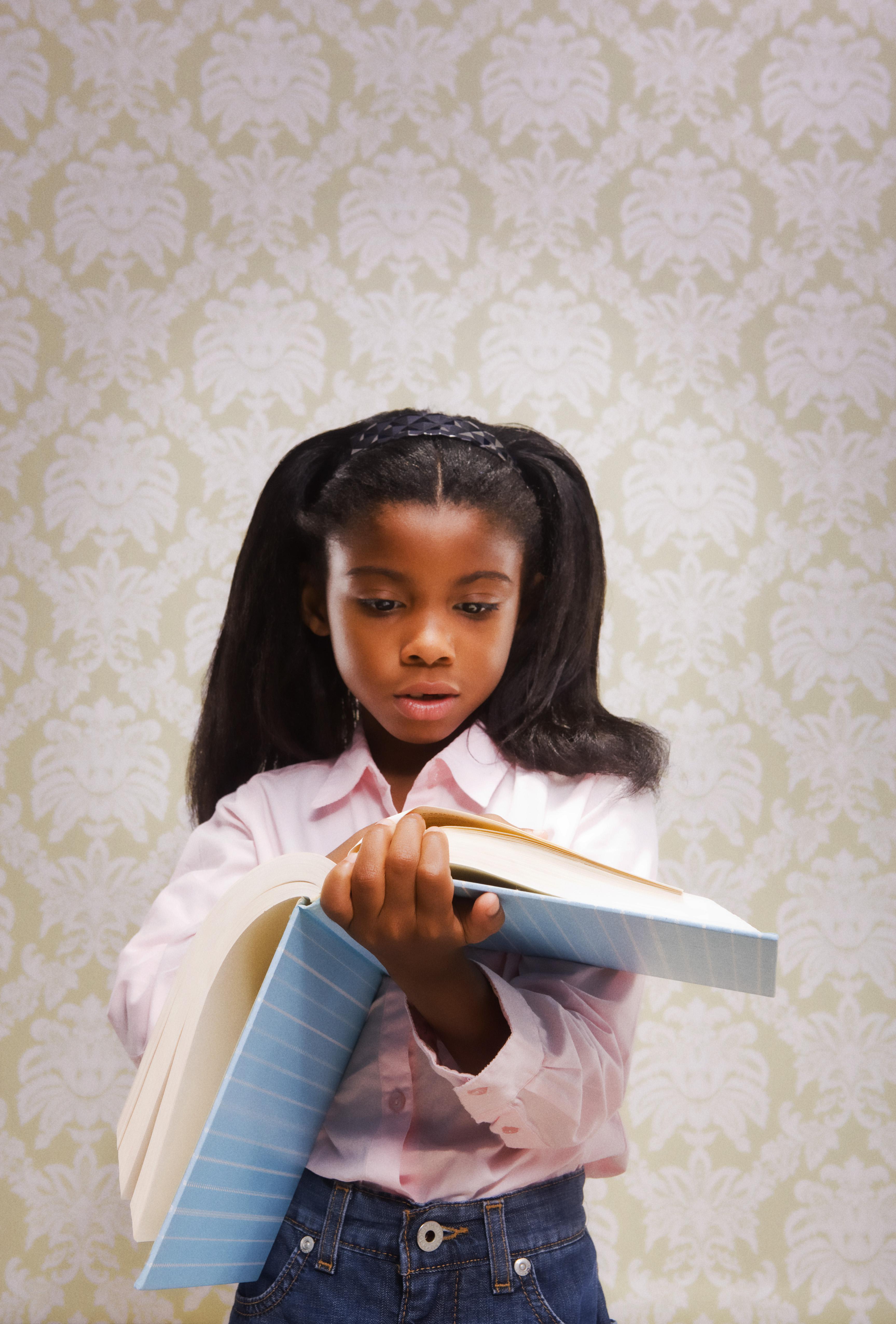 Girl thumbing through book