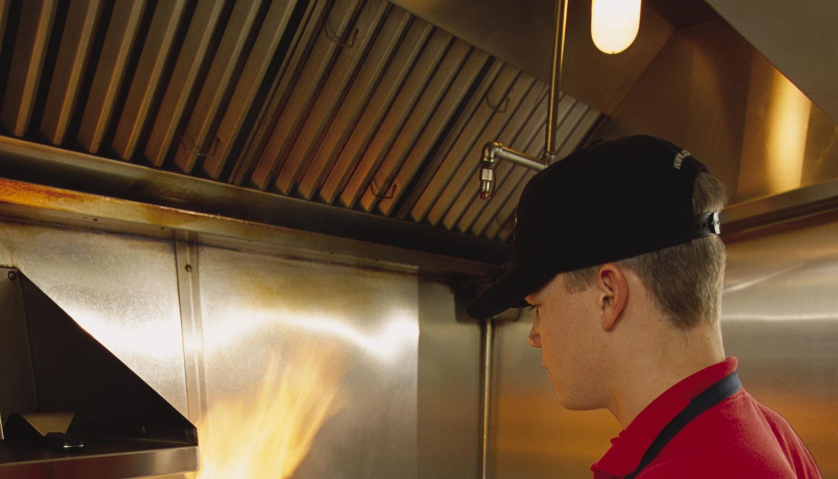 Fast food worker flips hamburgers