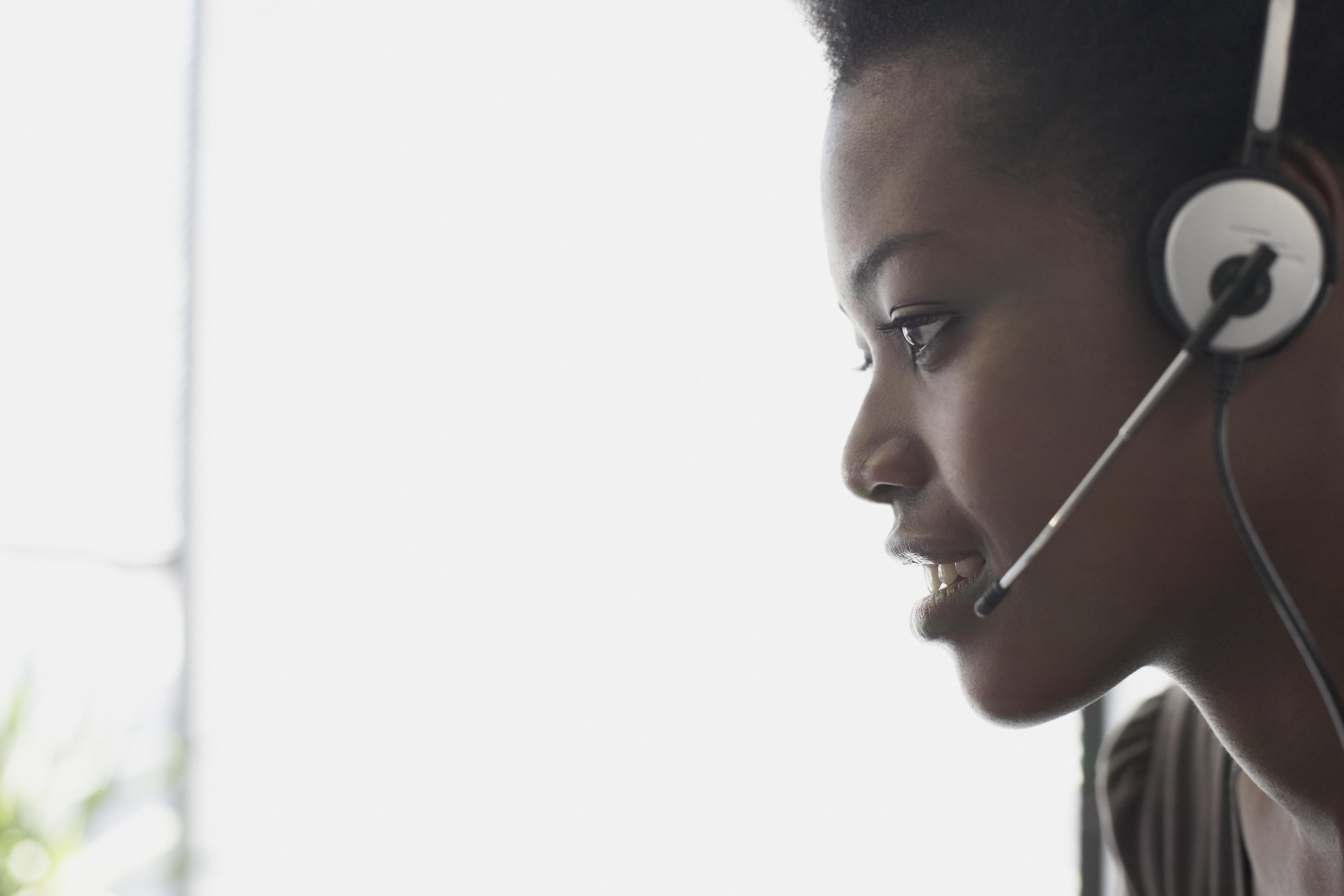 Woman wearing headset, profile, close-up
