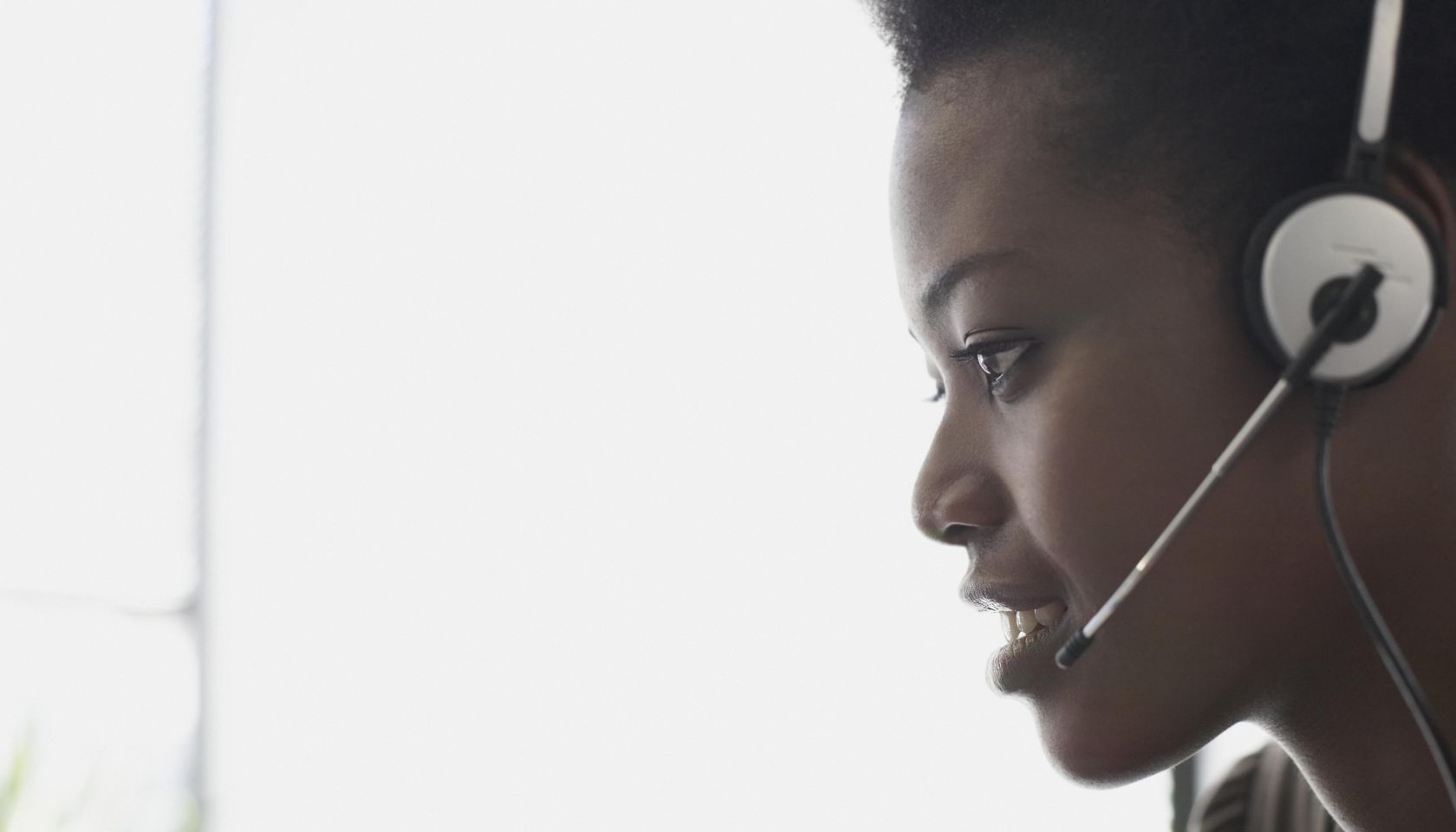 Woman wearing headset, profile, close-up