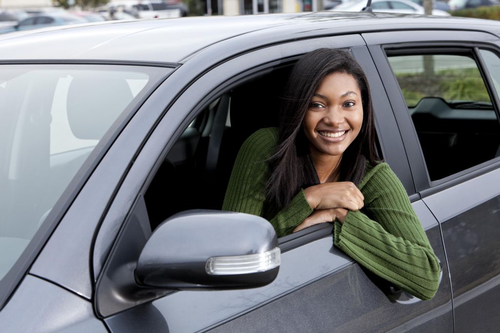 African American teenage girl driving car
