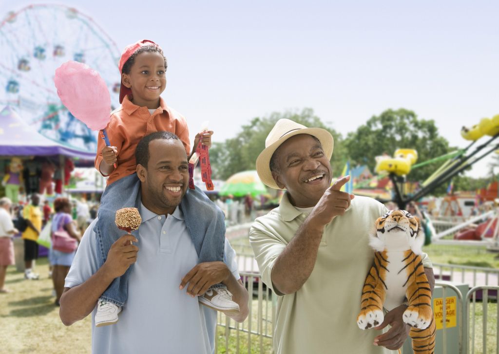 African-American grandfather with son and grandson at the fair