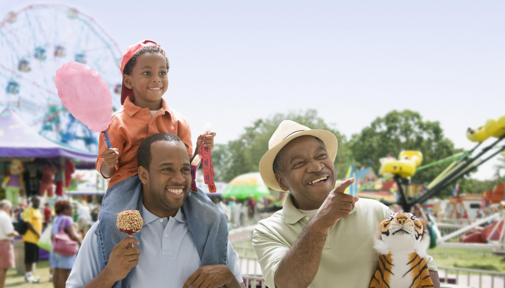 African-American grandfather with son and grandson at the fair