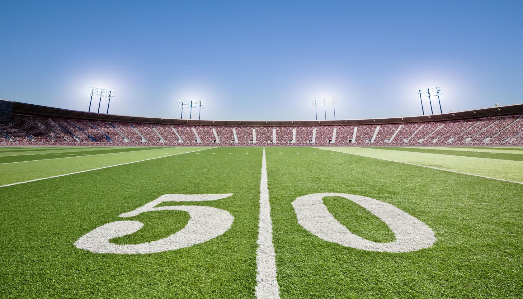 50 yard line on football field in stadium.