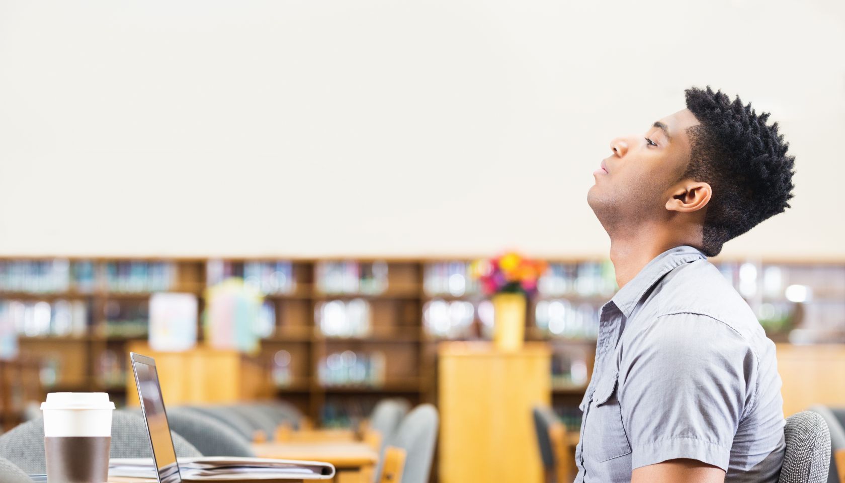 Tired or frustrated African American student studying late in library