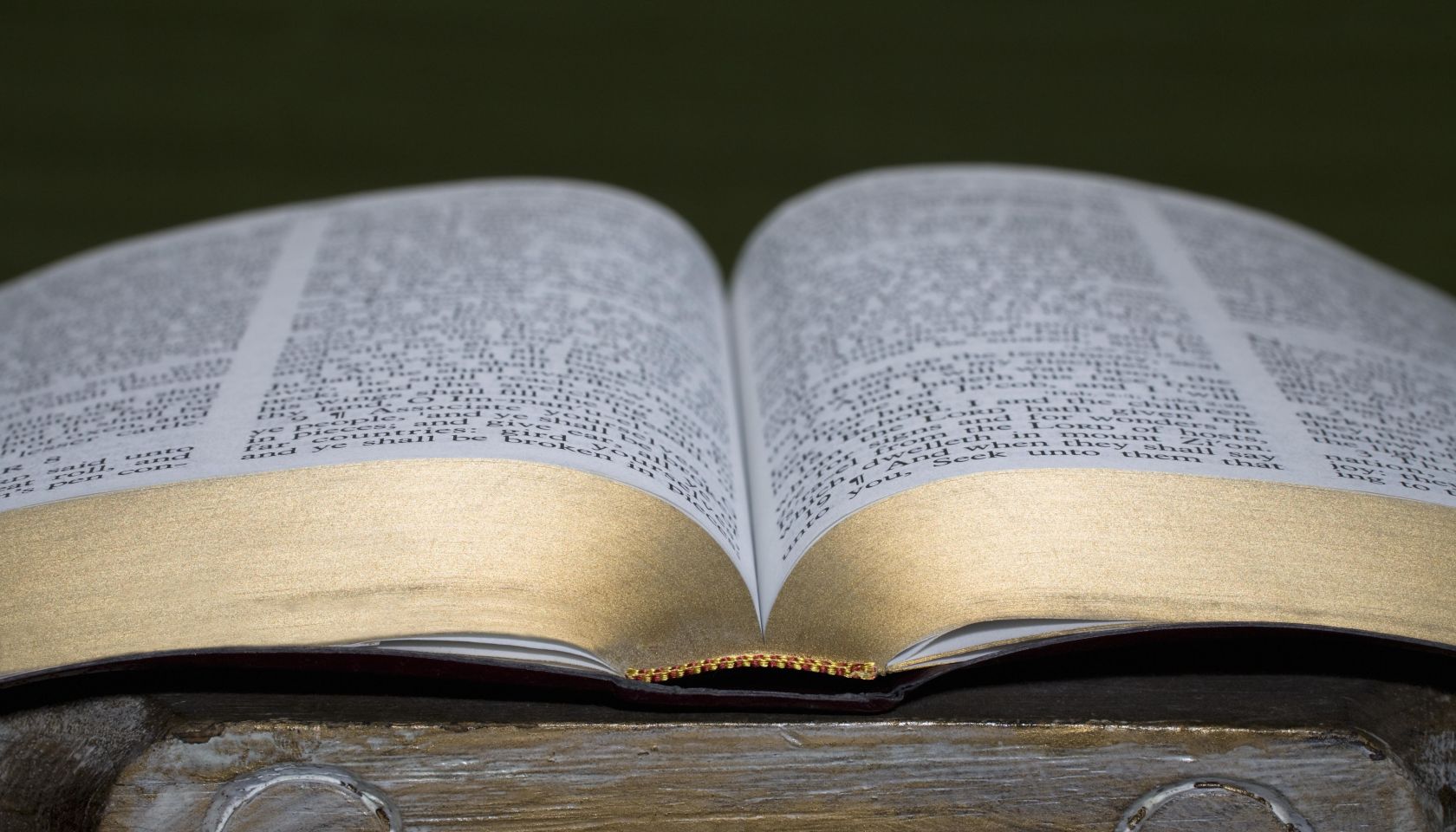 An open Bible on a pedestal