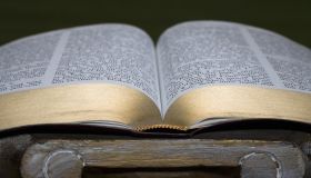 An open Bible on a pedestal