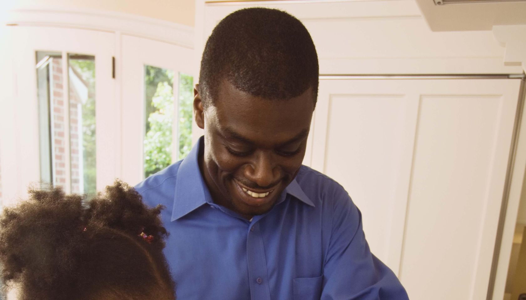 Father and daughter cooking greens