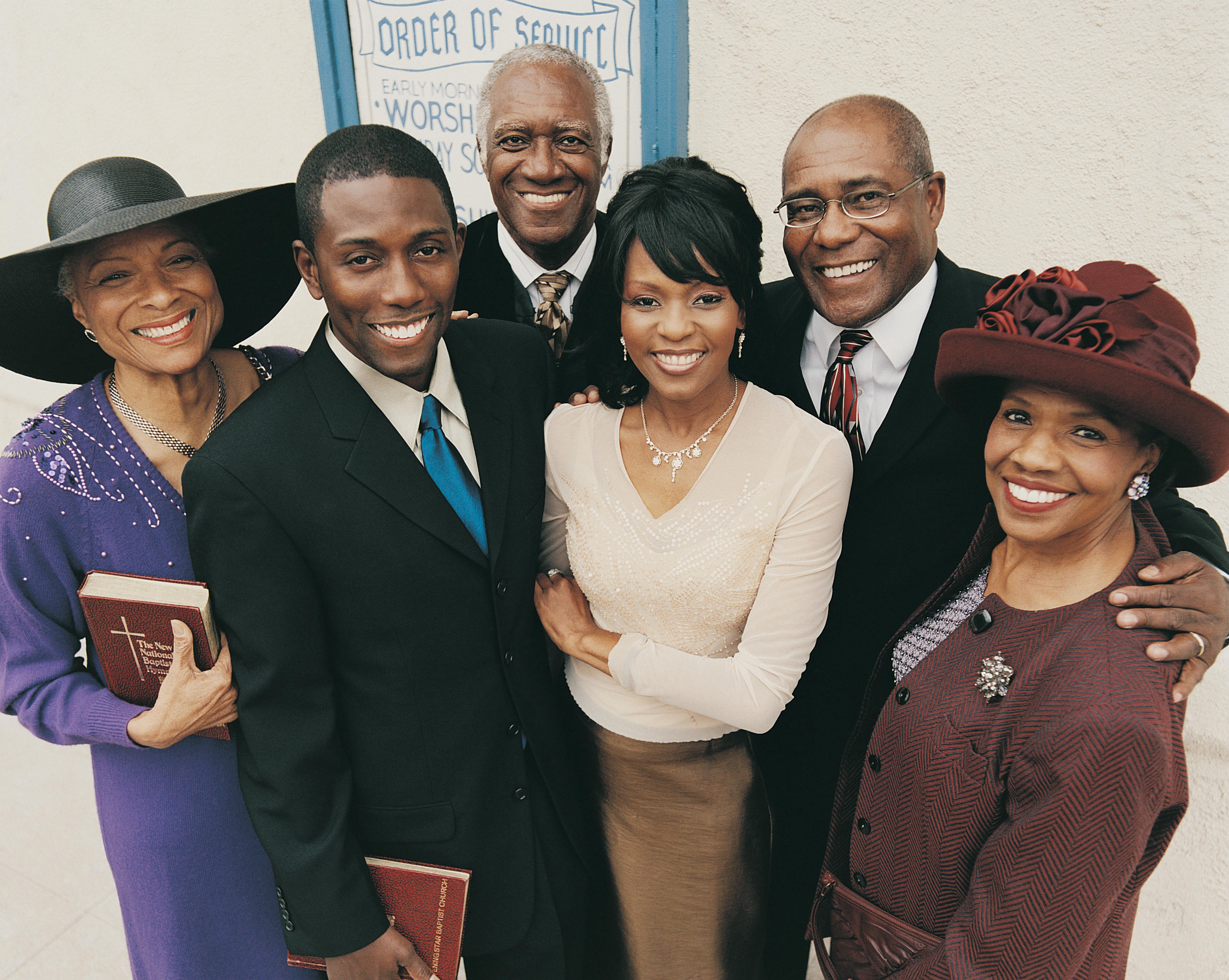 Portrait of a Group of Men and Woman Holding Bibles Outside a Church