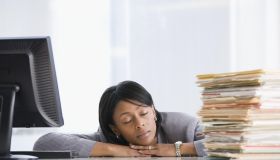 African American businesswoman sleeping at desk