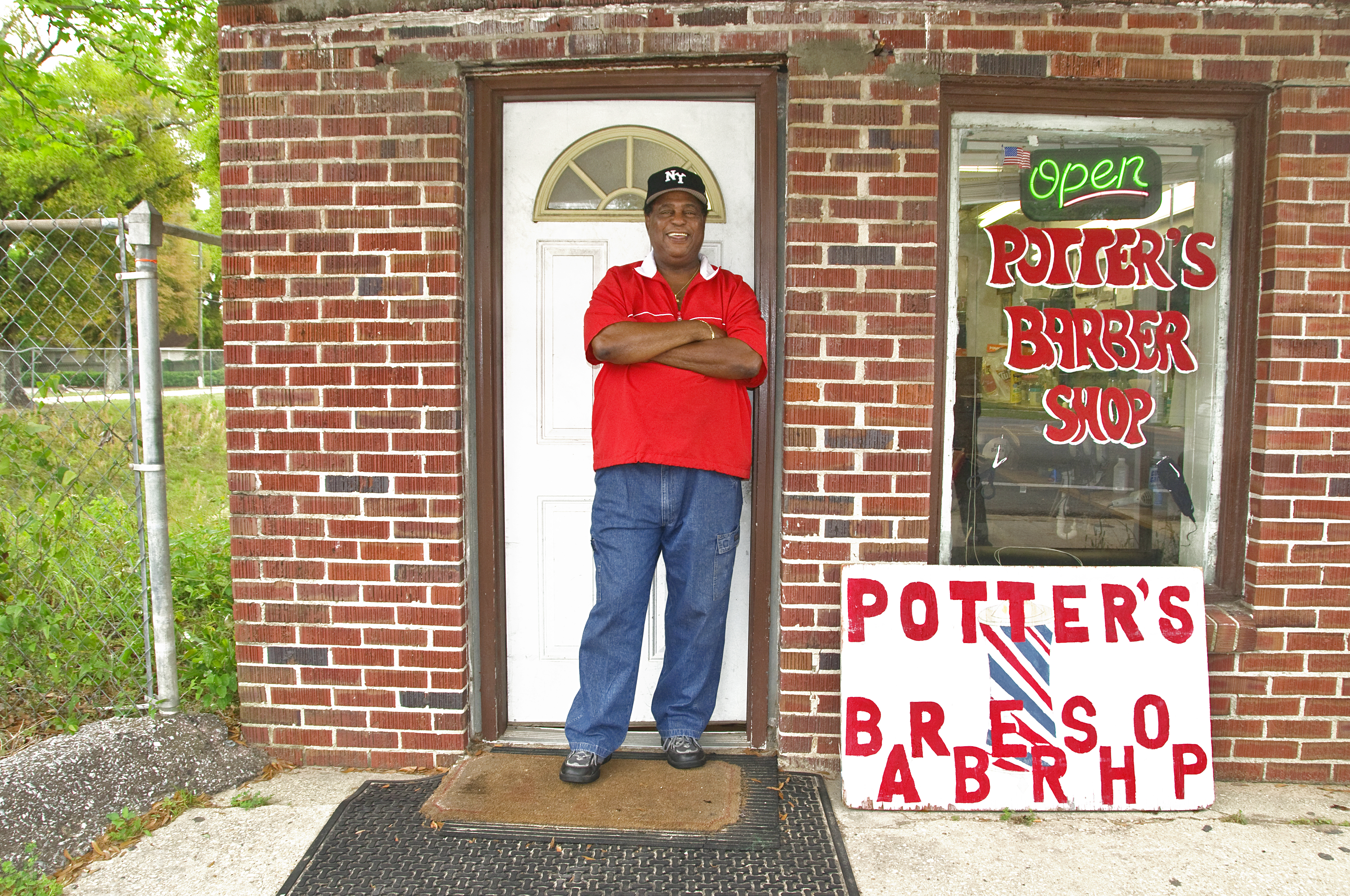 Barbershop owner in front of his own Barber Shop in Pensacola, Florida, USA