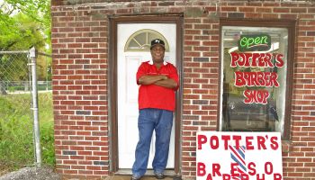 Barbershop owner in front of his own Barber Shop in Pensacola, Florida, USA