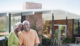 Older couple smiling in backyard