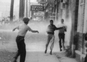 B/W 1963 authorities hosing demonstrators on sidewalk in civil rights riot / Alabama / newsreel