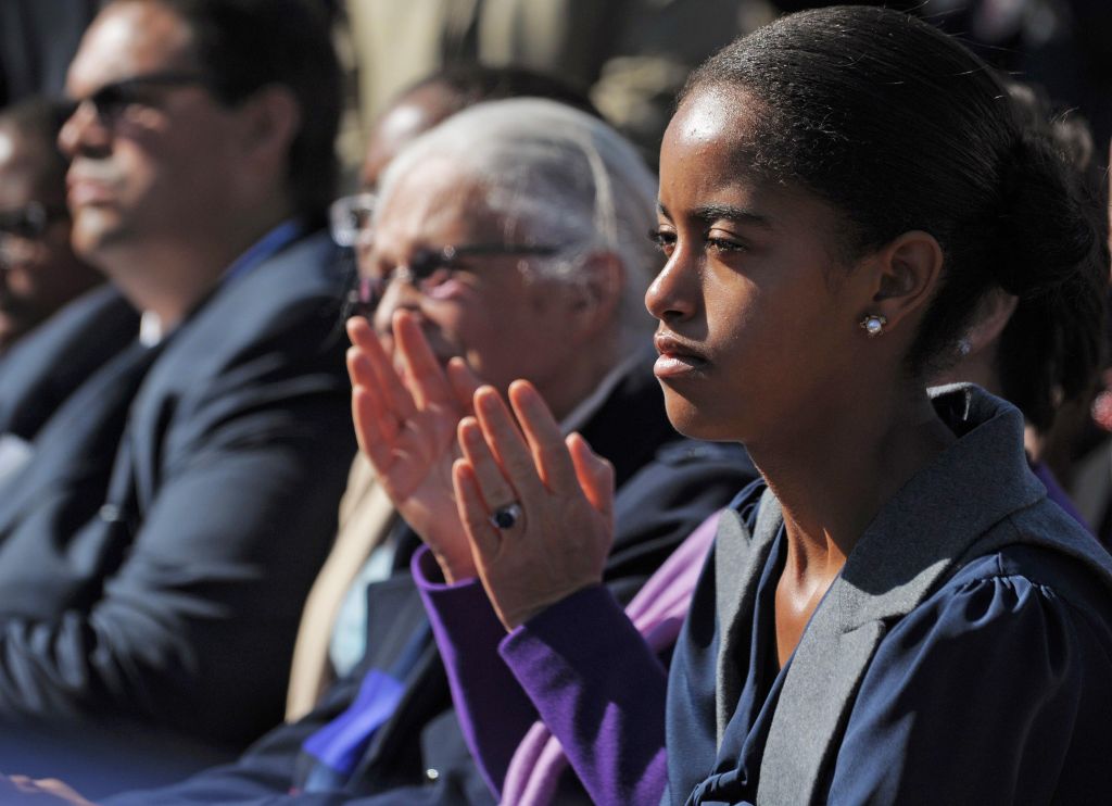 Malia Obama applauds as her father US Pr