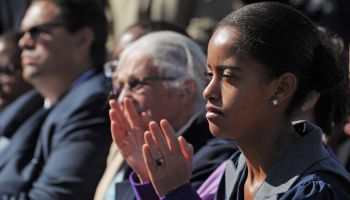 Malia Obama applauds as her father US Pr