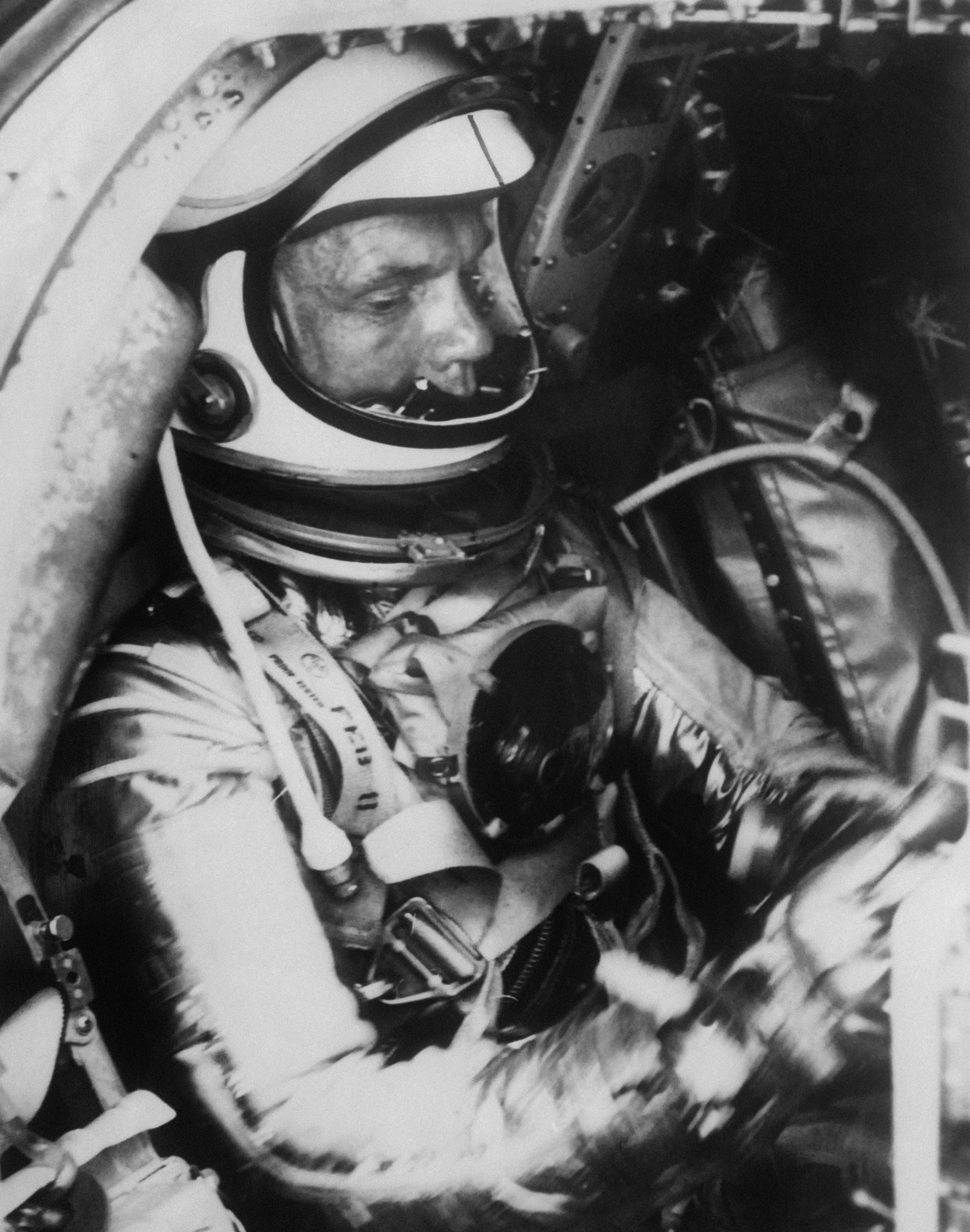 Astronaut Colonel John Glenn Training In His Spatial Suit Aboard Capsule Mercury Before Launching For Three Orbits Around Planet Earth...