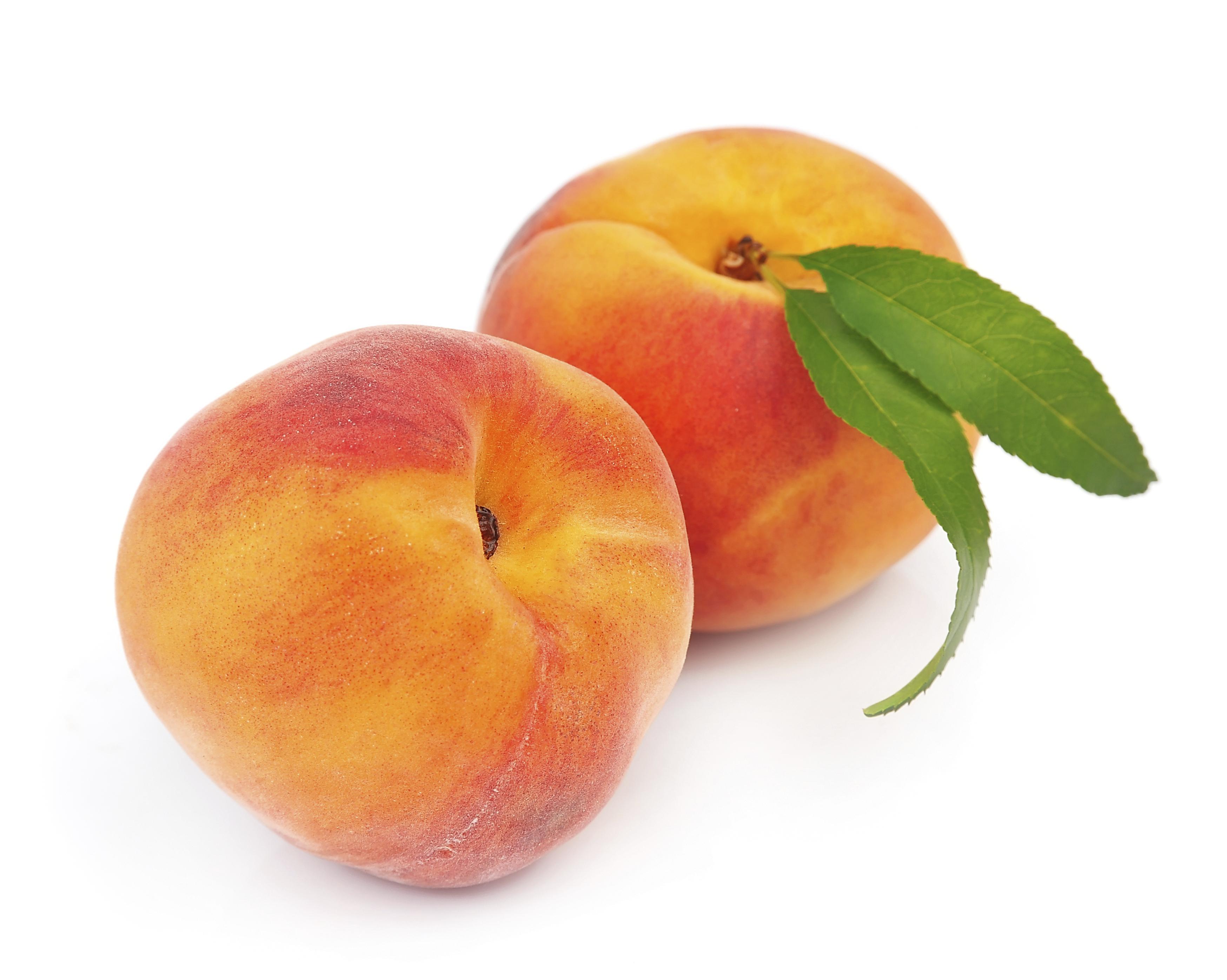 Sweet peaches with leafs on a white background