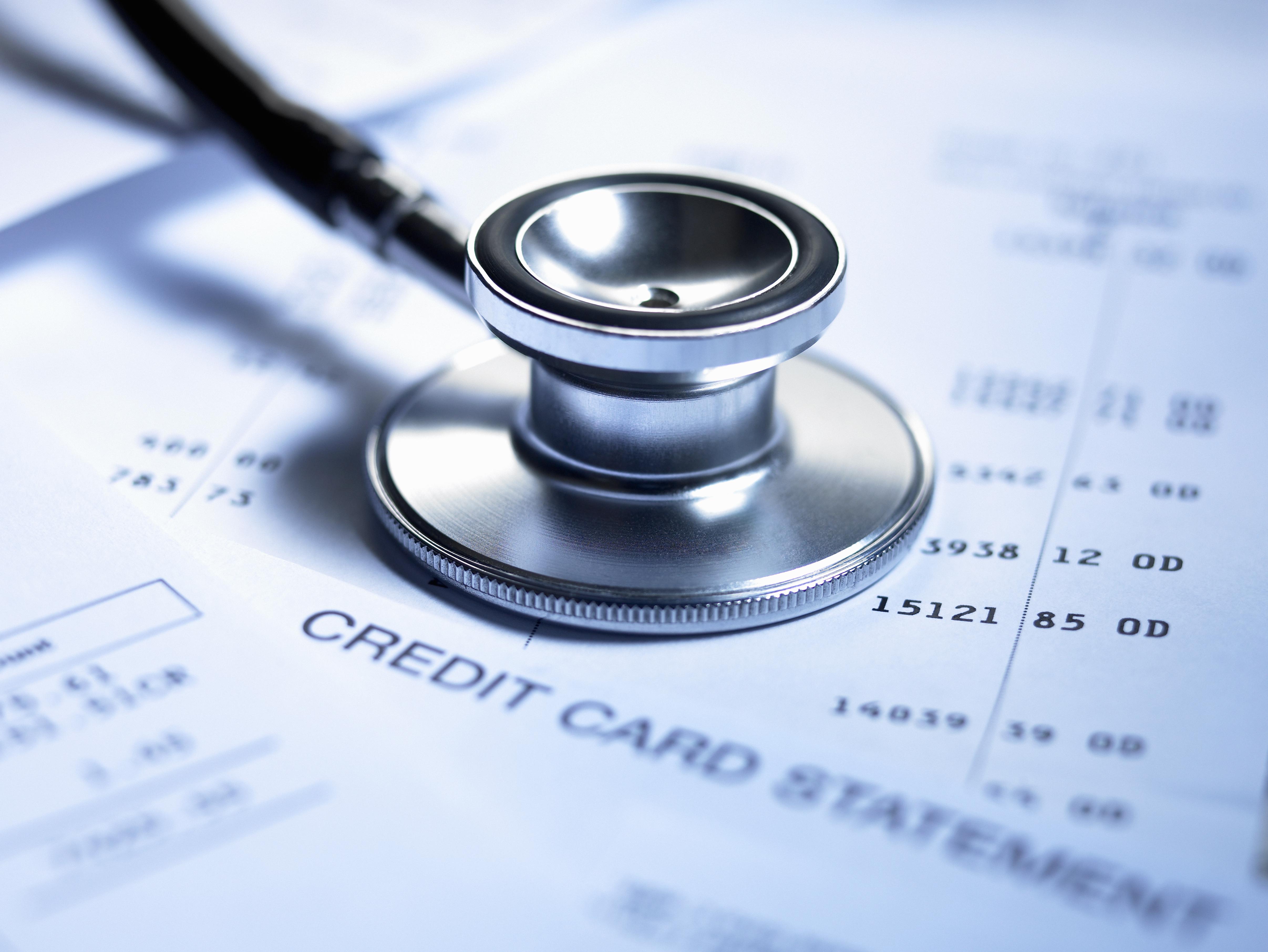 Stethoscope and credit card statement