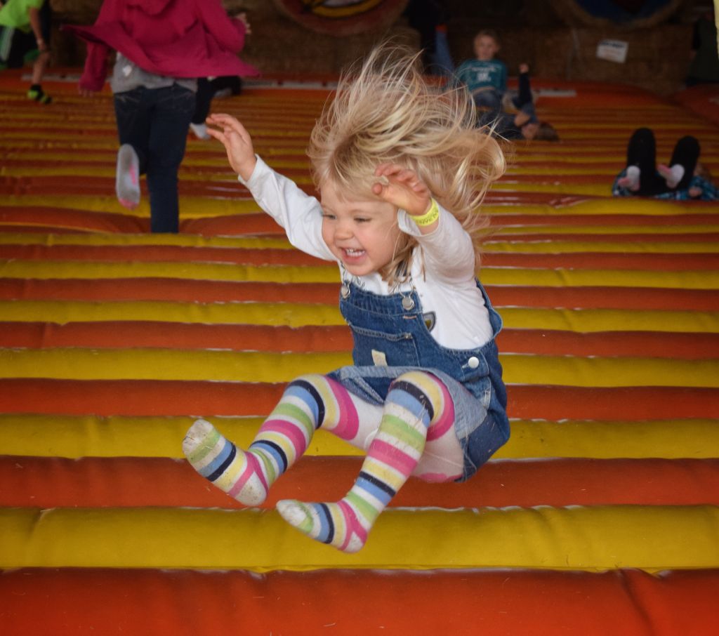Full Length Of Cheerful Girl On Bouncy Castle At Park