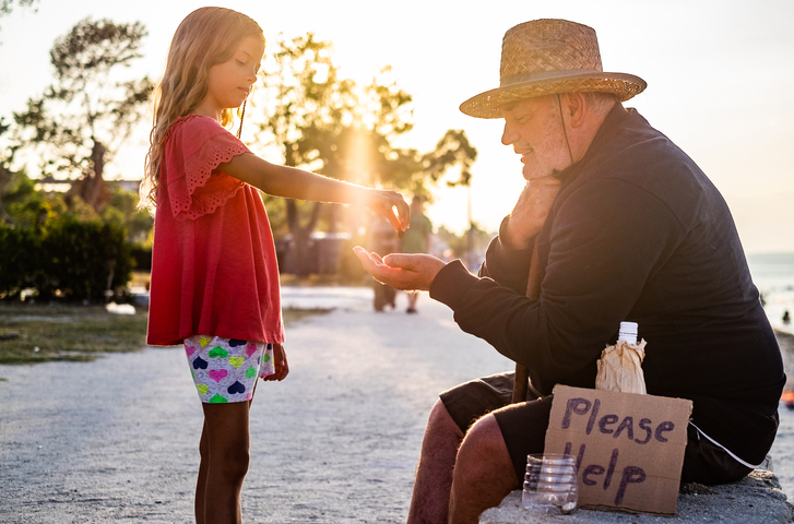 Beauty girl giving money to homeless men