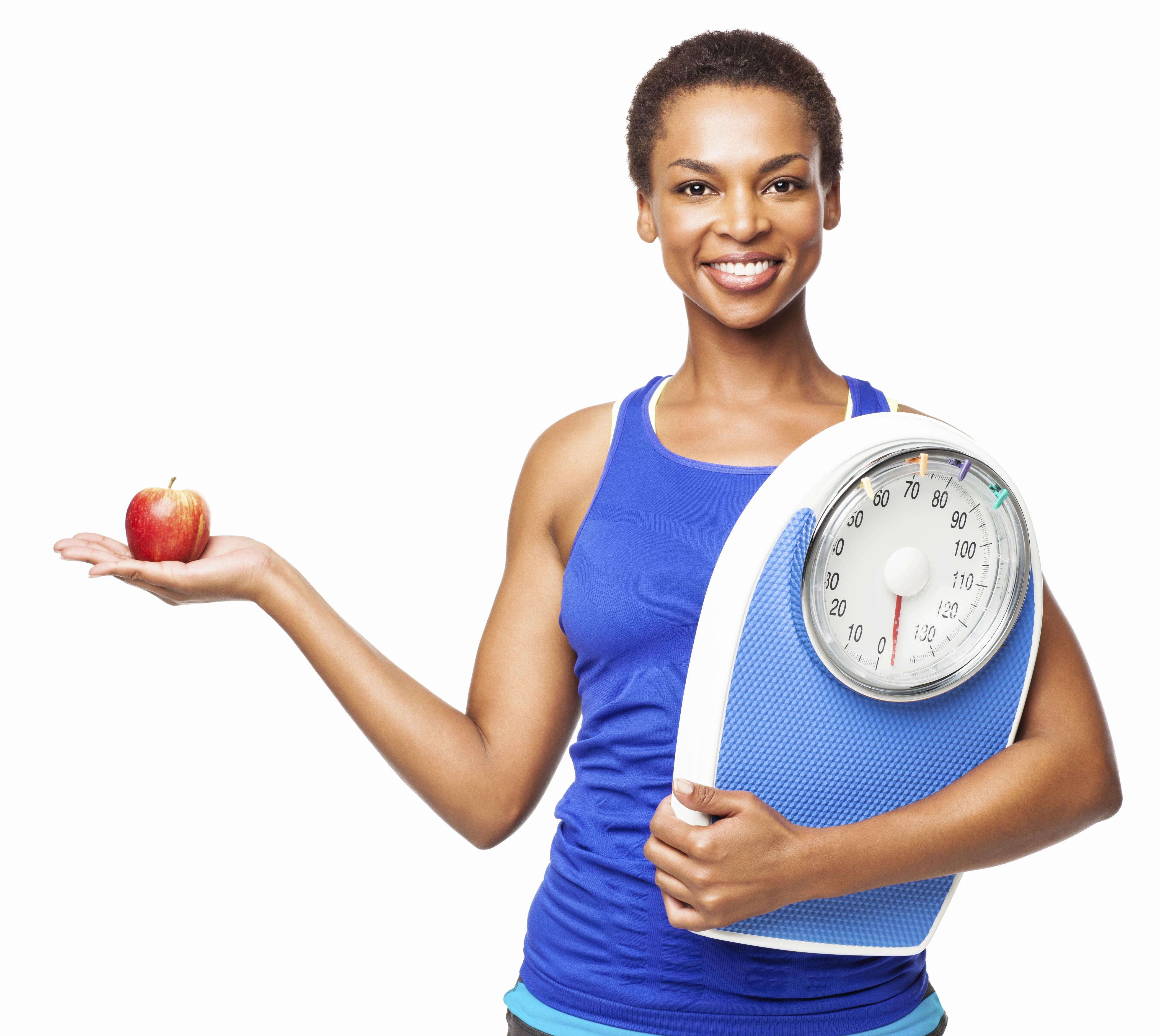 African American Woman Holding Weight Scale And Apple - Isolated