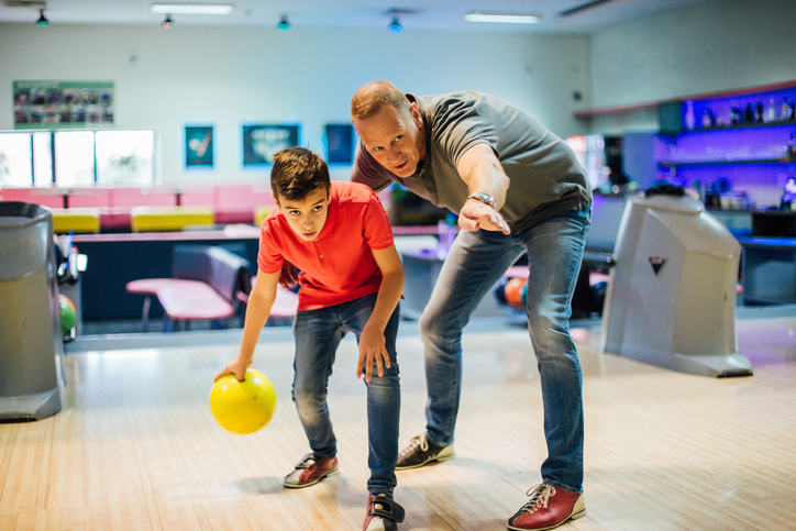 Man and his son bowling