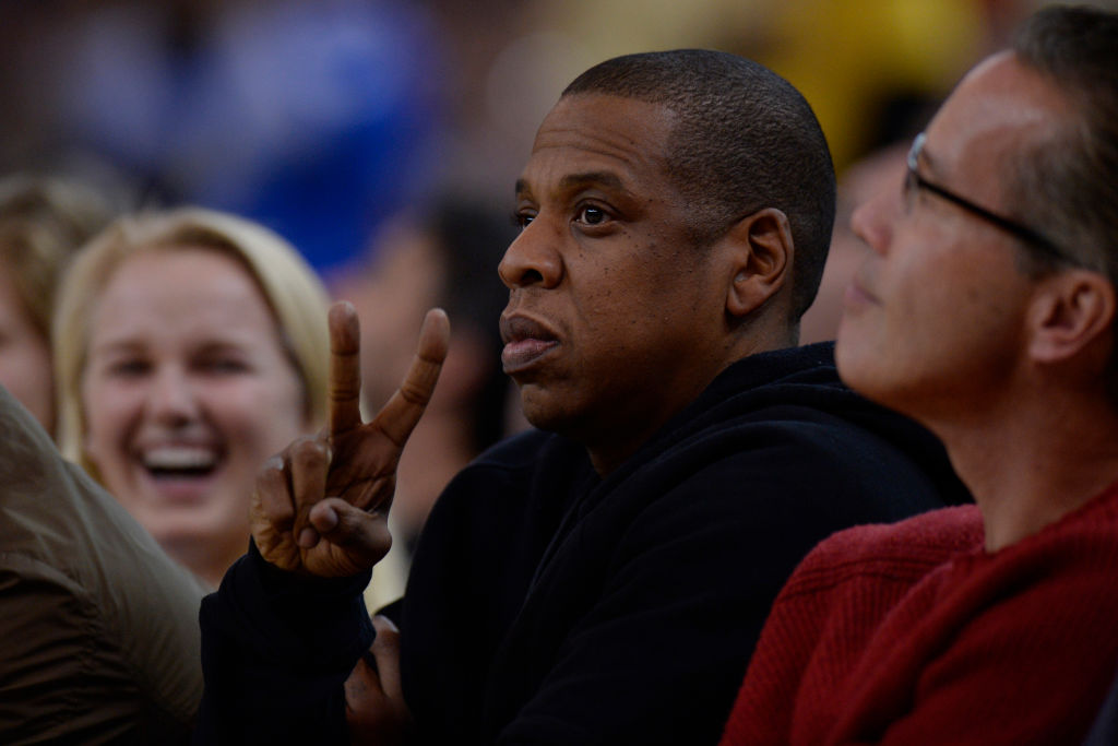 Rapper Jay-Z gestures while sitting court side as the Golden State Warriors play the San Antonio Spurs in the second quarter of their game at Oracle Arena in Oakland, Calif., on Monday, Jan. 25, 2016. (Jose Carlos Fajardo/Bay Area News Group)