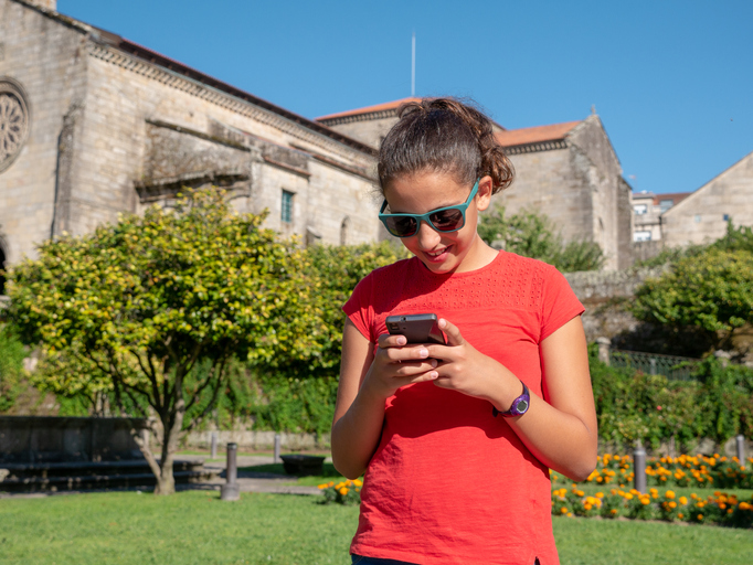 Young girl checking her smartphone