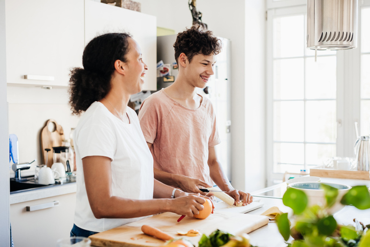 Single Mom Preparing Lunch With Son