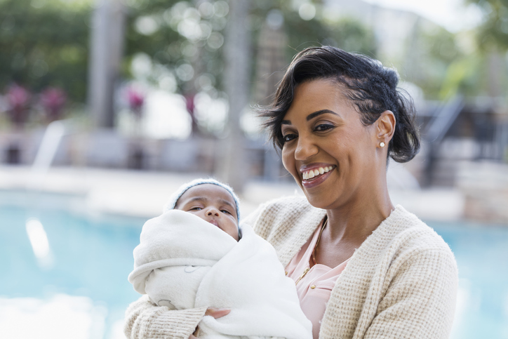 African-American mother with baby boy wrapped in blanket