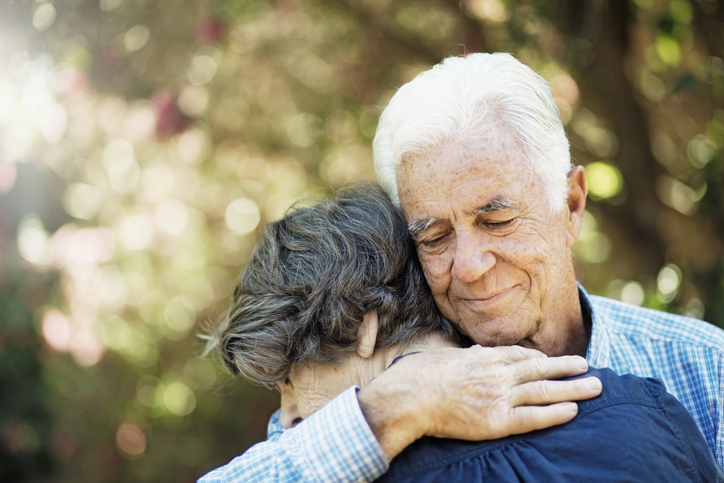 Senior couple in affectionate embrace in garden